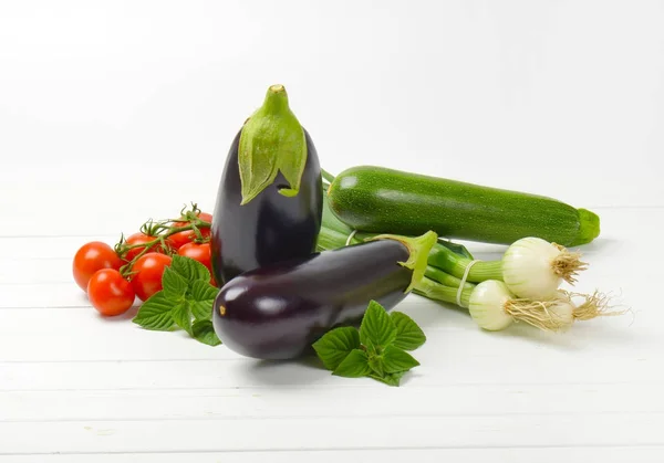 Fresh eggplants, tomatoes, zucchini and spring onion — Stock Photo, Image