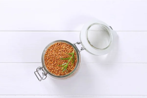 Jar of raw buckwheat — Stock Photo, Image