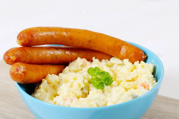 Thin sausages with potato salad — Stock Photo, Image