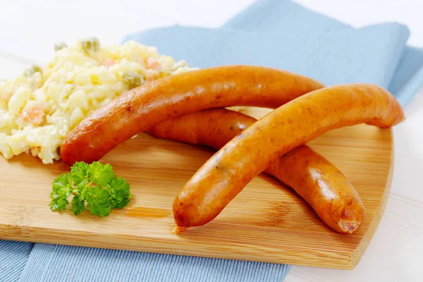 Thin sausages with potato salad — Stock Photo, Image