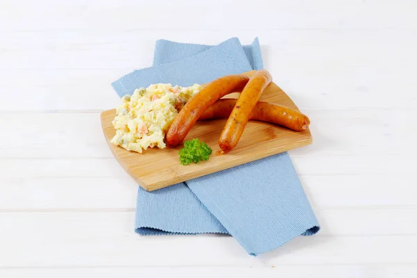 Thin sausages with potato salad — Stock Photo, Image