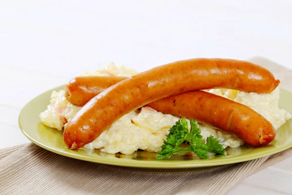 Thin sausages with potato salad — Stock Photo, Image