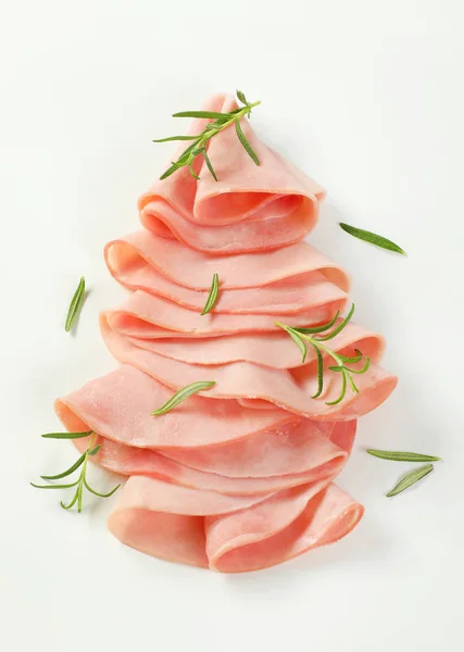 Thin slices of ham with rosemary — Stock Photo, Image