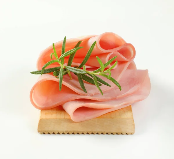 Thin slices of ham and rosemary — Stock Photo, Image