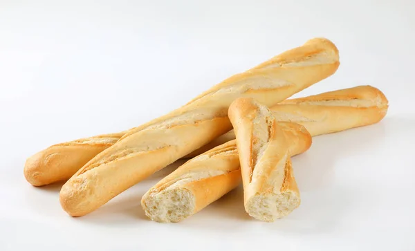 Whole and halved French baguettes — Stock Photo, Image