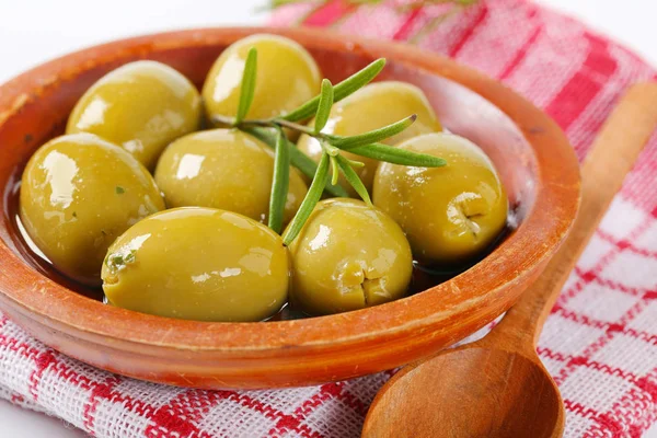 Bowl of green olives with rosemary — Stock Photo, Image