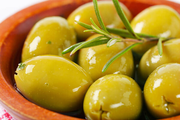 bowl of green olives with rosemary