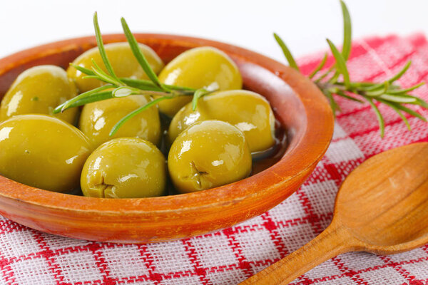 bowl of green olives with rosemary