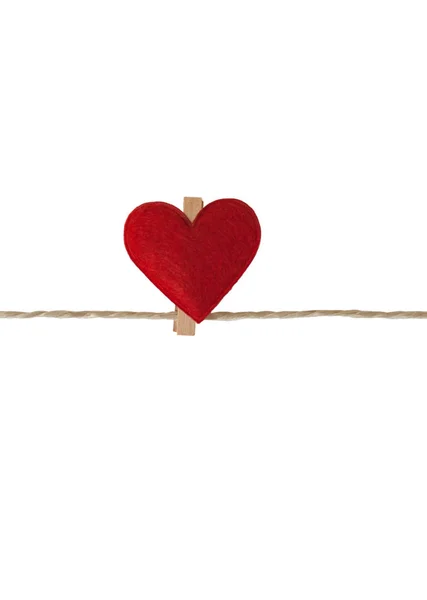 One heart with clothes pegs on a cord, isolated on white Stock Picture