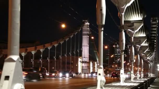 Krymsky Bridge or Crimean Bridge and traffic of cars (night)-- is a steel suspension bridge in Moscow, Russia. The bridge spans the Moskva River 1,800 metres south-west from the Kremlin — Stock Video