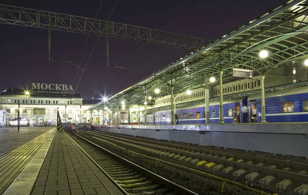 Tåg på Moskva passagerare plattform på natten (Belorussky järnvägsstation)--är en av de nio viktigaste järnvägsstationerna i Moskva. Det var öppnade 1870 och återuppbyggdes i sin nuvarande form år 1907-1912 — Stockfoto