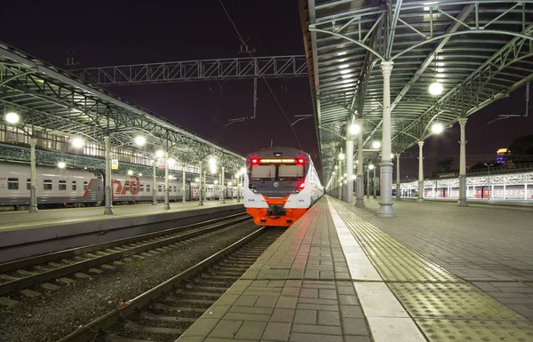 Treno sulla piattaforma passeggeri di Mosca di notte (stazione ferroviaria Belorussky) -- è una delle nove stazioni ferroviarie principali a Mosca, Russia. Fu aperto nel 1870 e ricostruito nella sua forma attuale nel 1907-1912 — Foto Stock