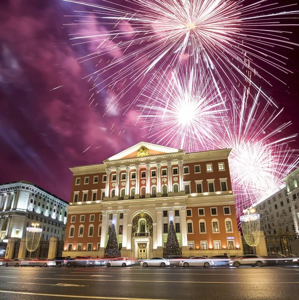 Fireworks over the Christmas and New Year holidays illumination in Moscow city center and Government building on Tverskaya street at night, Russia
