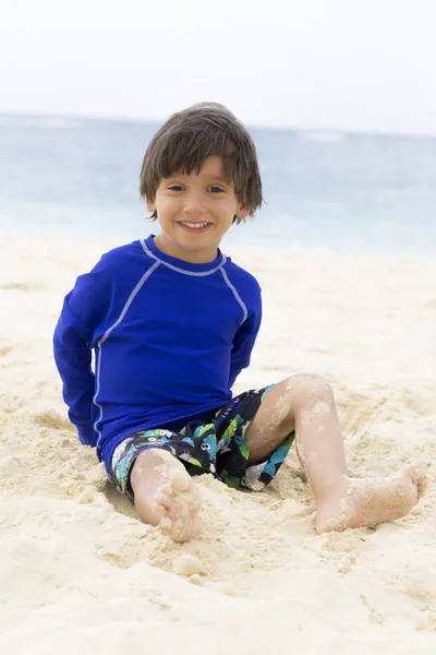 Счастливый мальчик, играющий на пляже — стоковое фото