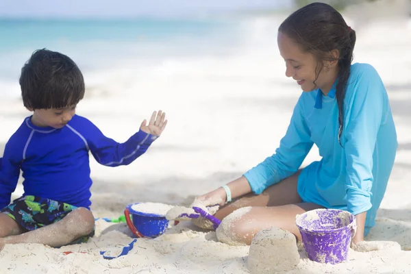 Szczęśliwa dziewczyna i chłopak gra na plaży — Zdjęcie stockowe