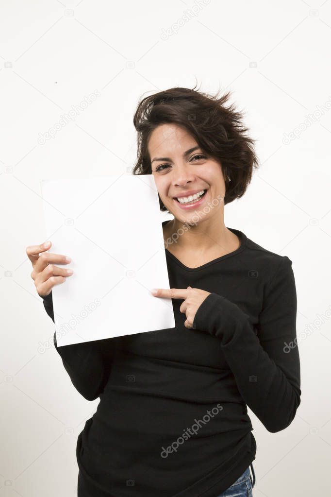 Beautiful young woman holding a blank sheet of paper. Space for your text. Isolated on white.