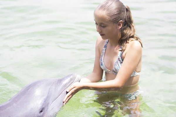 Vacation Lifestyle -Happy teenager hugging a dolphin — Stock Photo, Image