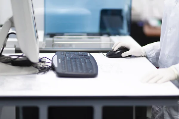 Female Nurse Working on Laptop Computer In Lab