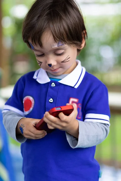 Härlig Pojke Med Målat Ansikte Spela Mobiltelefon — Stockfoto