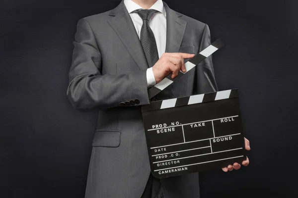 Man wearing costume holding movie clapper board — Stock Photo, Image