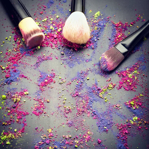 Top view of make-up brushes on background with make-up powder