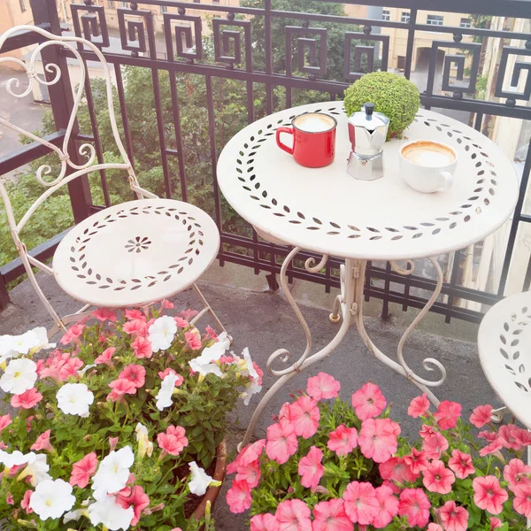 Coffee cups on white table on balcony outdoors