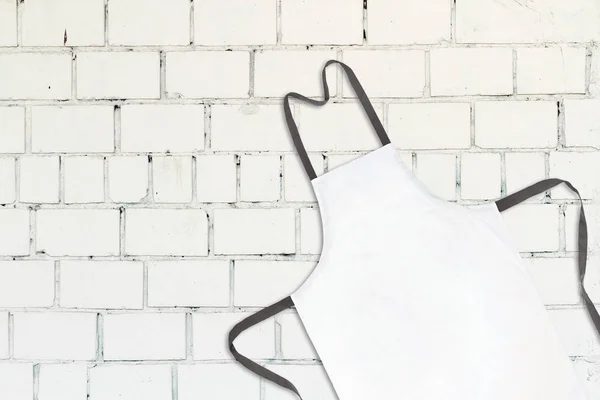 White apron on white brick wall — Stock Photo, Image