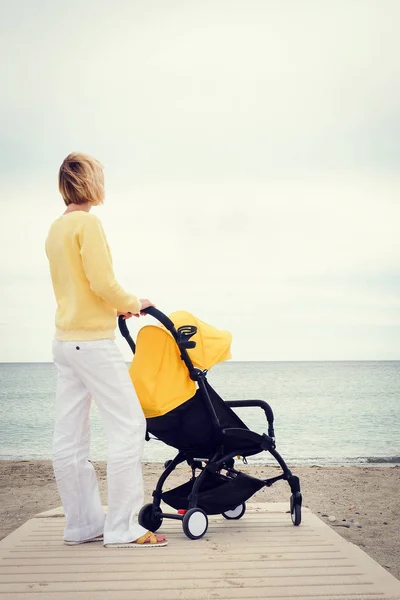 Mother on a walk with stroller — Stock Photo, Image
