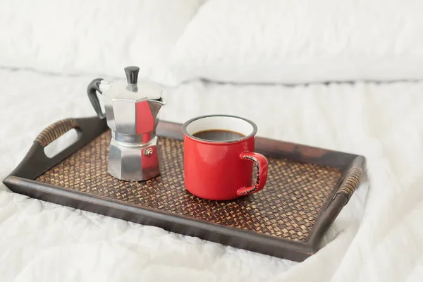 Coffee with steel coffee percolator on bed