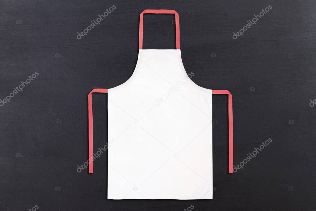 Apron on black chalkboard texture