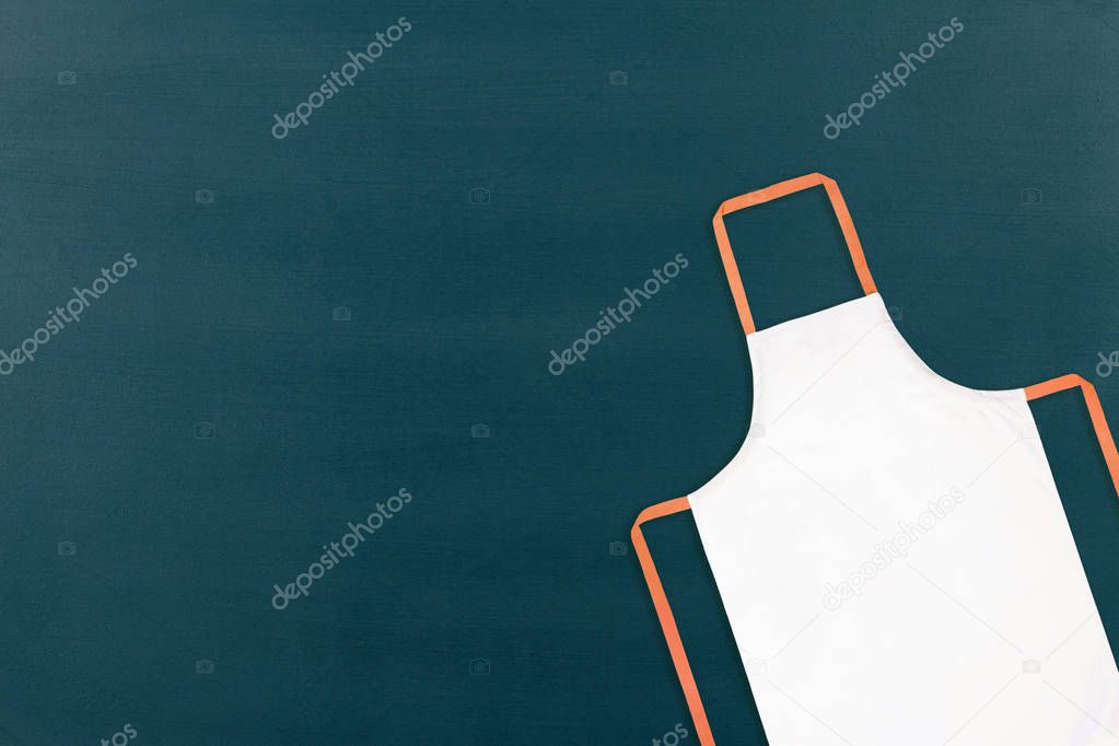 White apron on blank chalkboard background