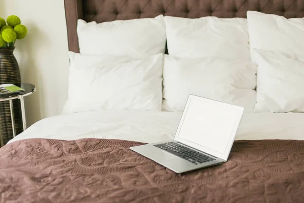 Laptop on bed with pillows — Stock Photo, Image