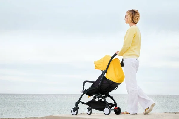 Mother on a walk with stroller — Stock Photo, Image