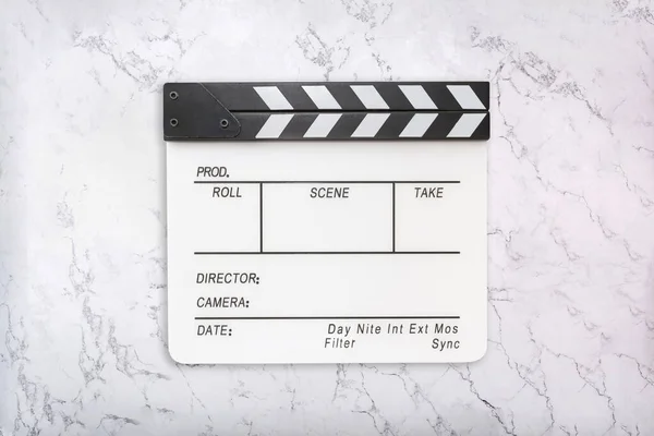 White clapboard on white marble background. Flat lay of clapper board on natural marble texture — Stock Photo, Image
