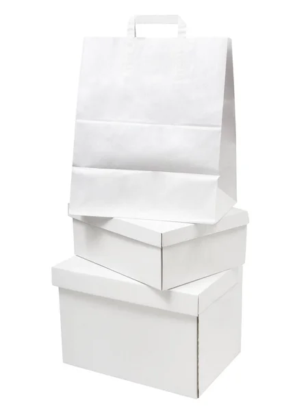 Stapel lege witte papieren dozen en papieren zak verpakkingen geïsoleerd op witte achtergrond — Stockfoto