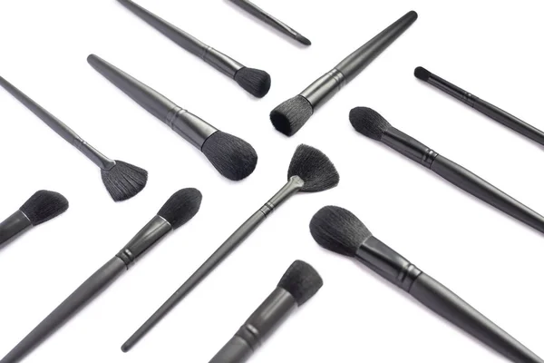 Flat lay of black makeup brushes collection isolated on white background — Stock Photo, Image