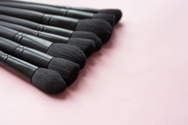 Closeup of makeup brushes on pink background — Stock Photo, Image