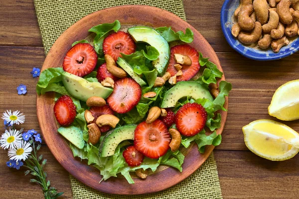 Strawberry Avocado Lettuce Salad Cashew Nuts Plate Photographed Overhead Dark — Stock Photo, Image