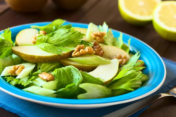 Fresh Celery Pear Walnut Salad Blue Plate Half Lemons Back — Stock Photo, Image