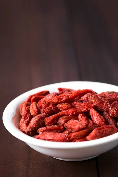 Dried Gojis Wolfberries Small Bowl Photographed Dark Wood Natural Light — Stock Photo, Image