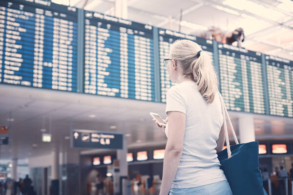 Girl near airline schedule