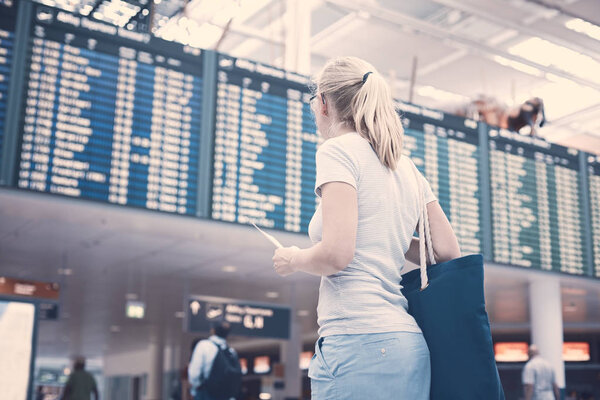 Girl near airline schedule