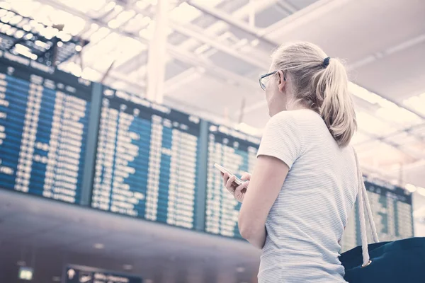 Girl near airline schedule — Stock Photo, Image