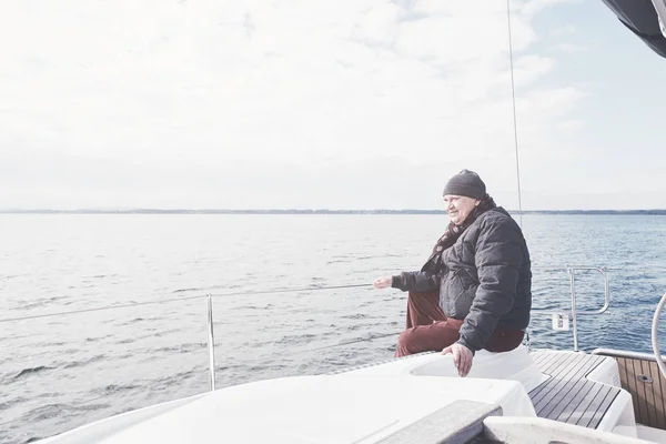 Aged man on sailboat — Stock Photo, Image