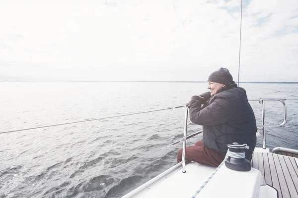 Aged man on sailboat — Stock Photo, Image