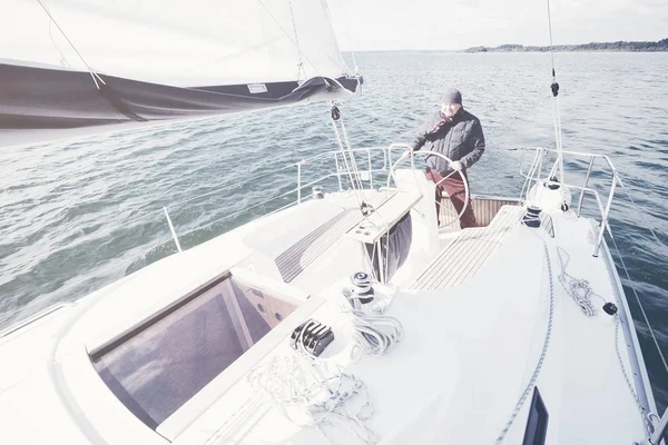 Aged man on sailboat — Stock Photo, Image