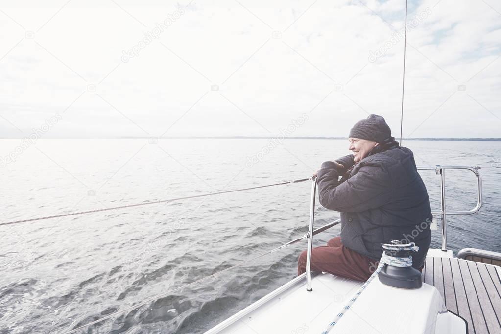 Aged man on sailboat