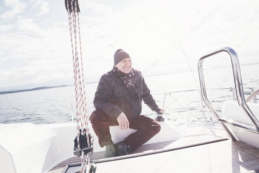 Aged man on sailboat