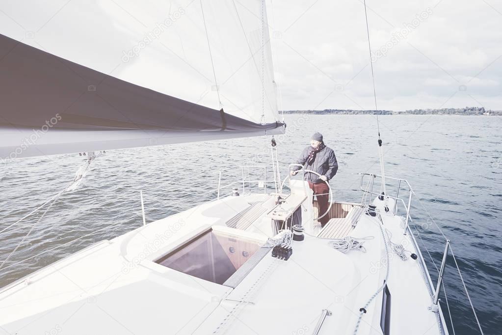 Aged man on sailboat