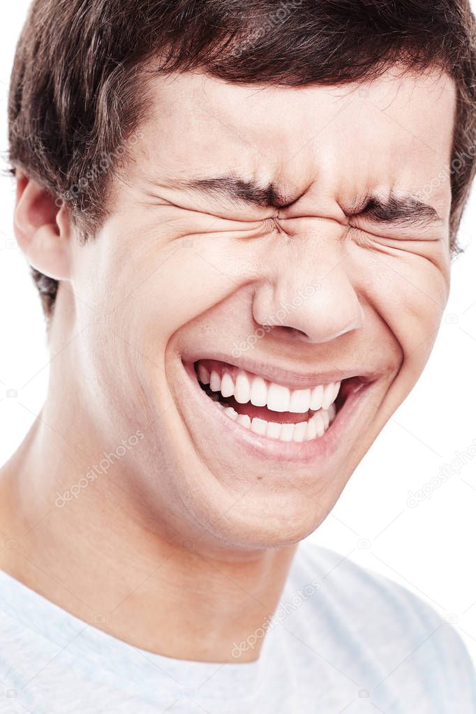 Man laughing out loud with closed eyes